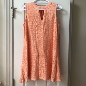 Peach colored dress.